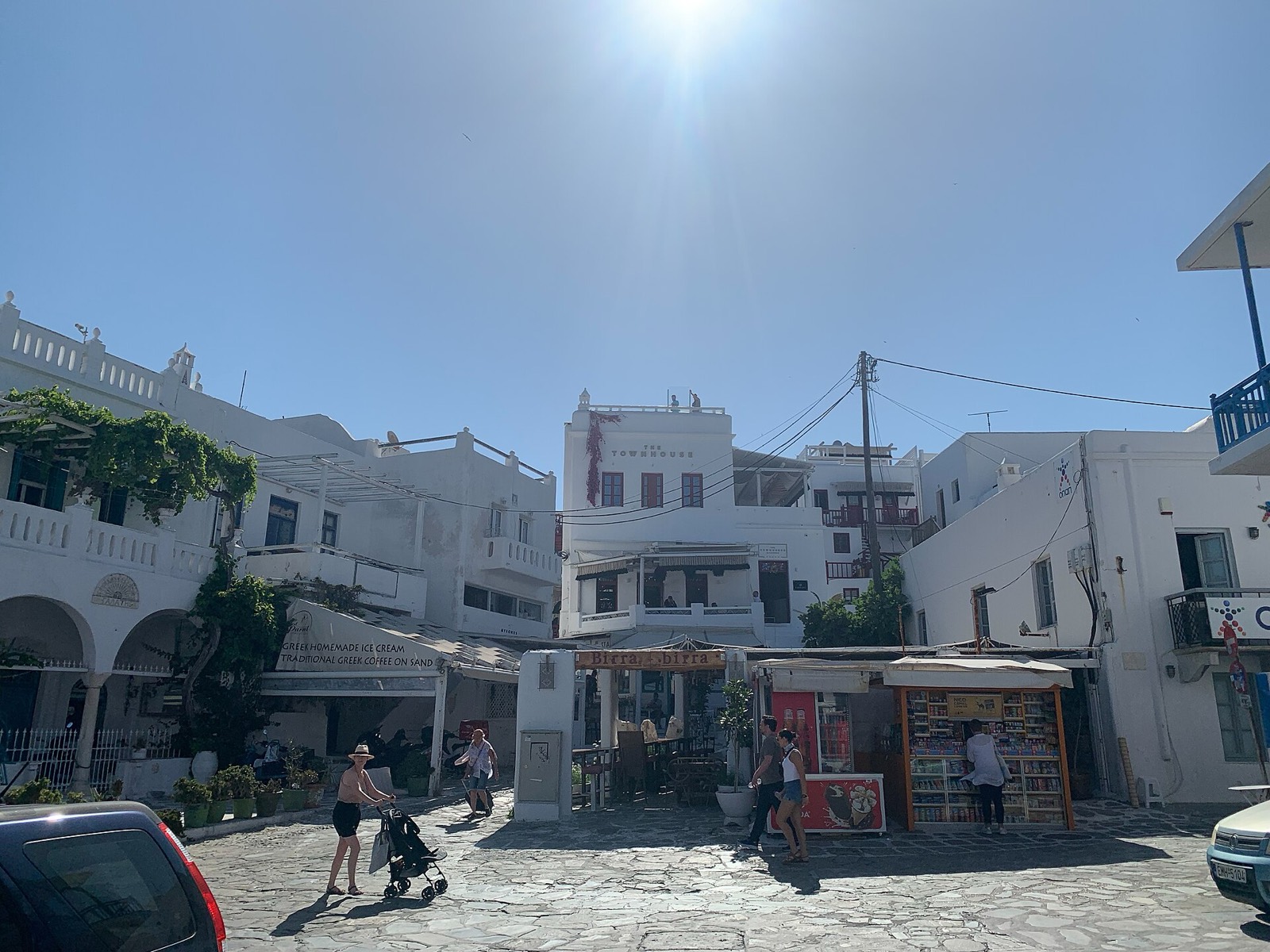 Whitewashed shops and cafés on a square at the edge of Chora