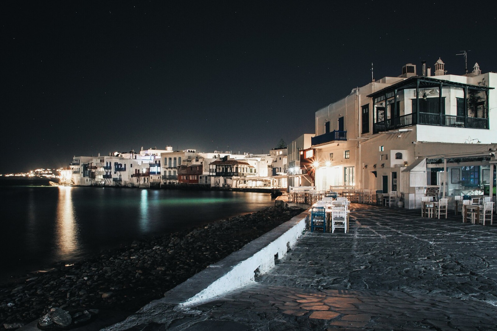 Little Venice houses and bars lit at night over the sea