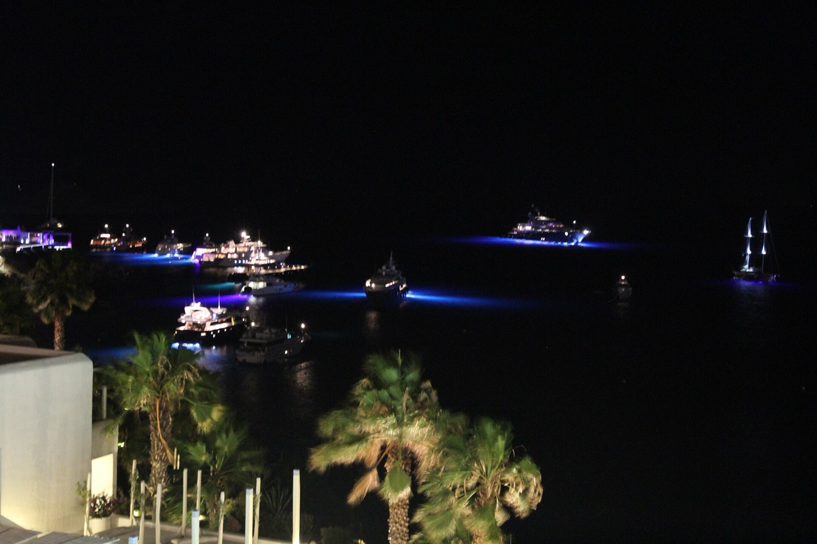 Platis Gialos beach at night with yachts lit in the bay