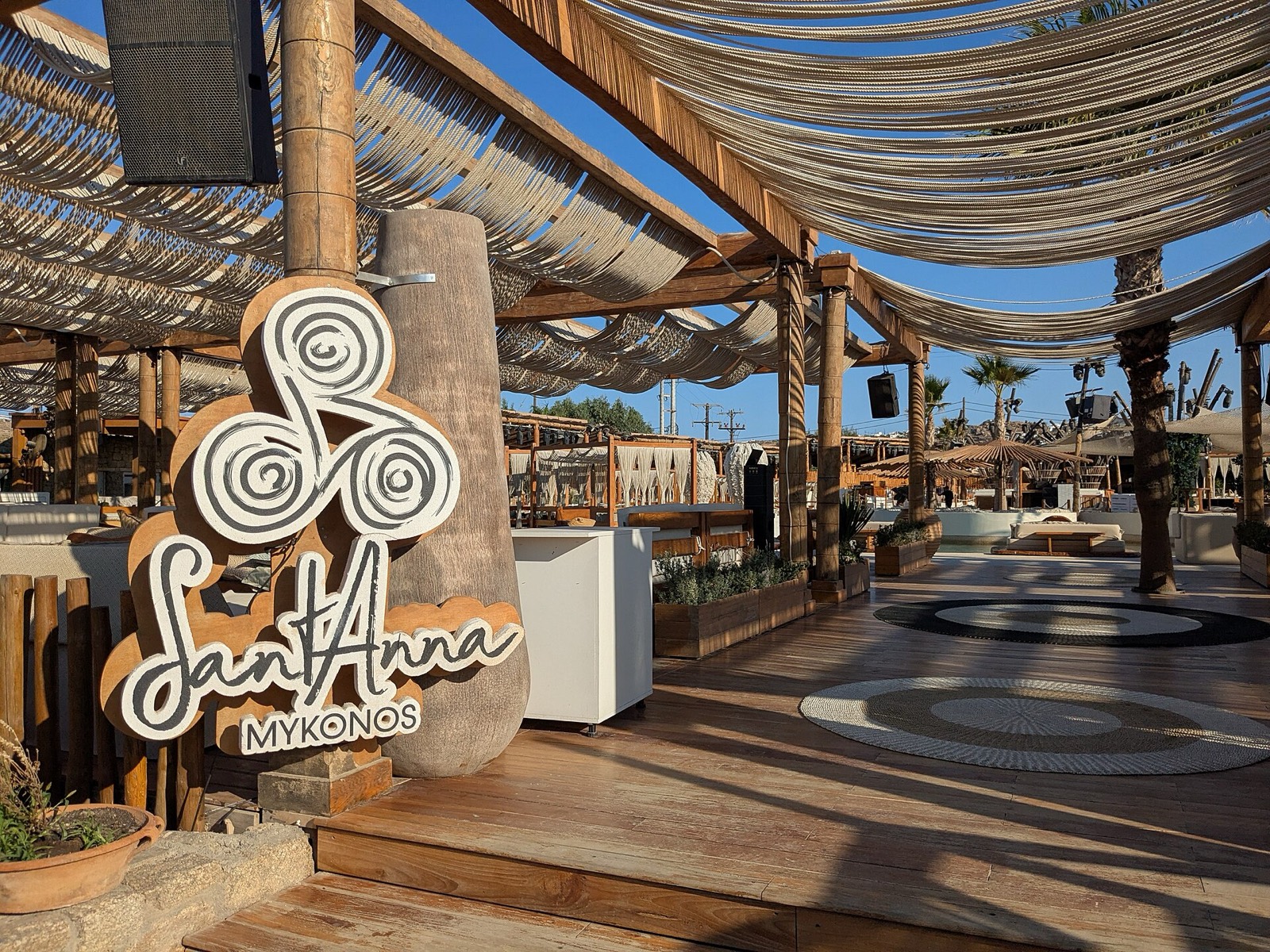 SantAnna beach club on Paraga, with the venue sign on the wooden deck