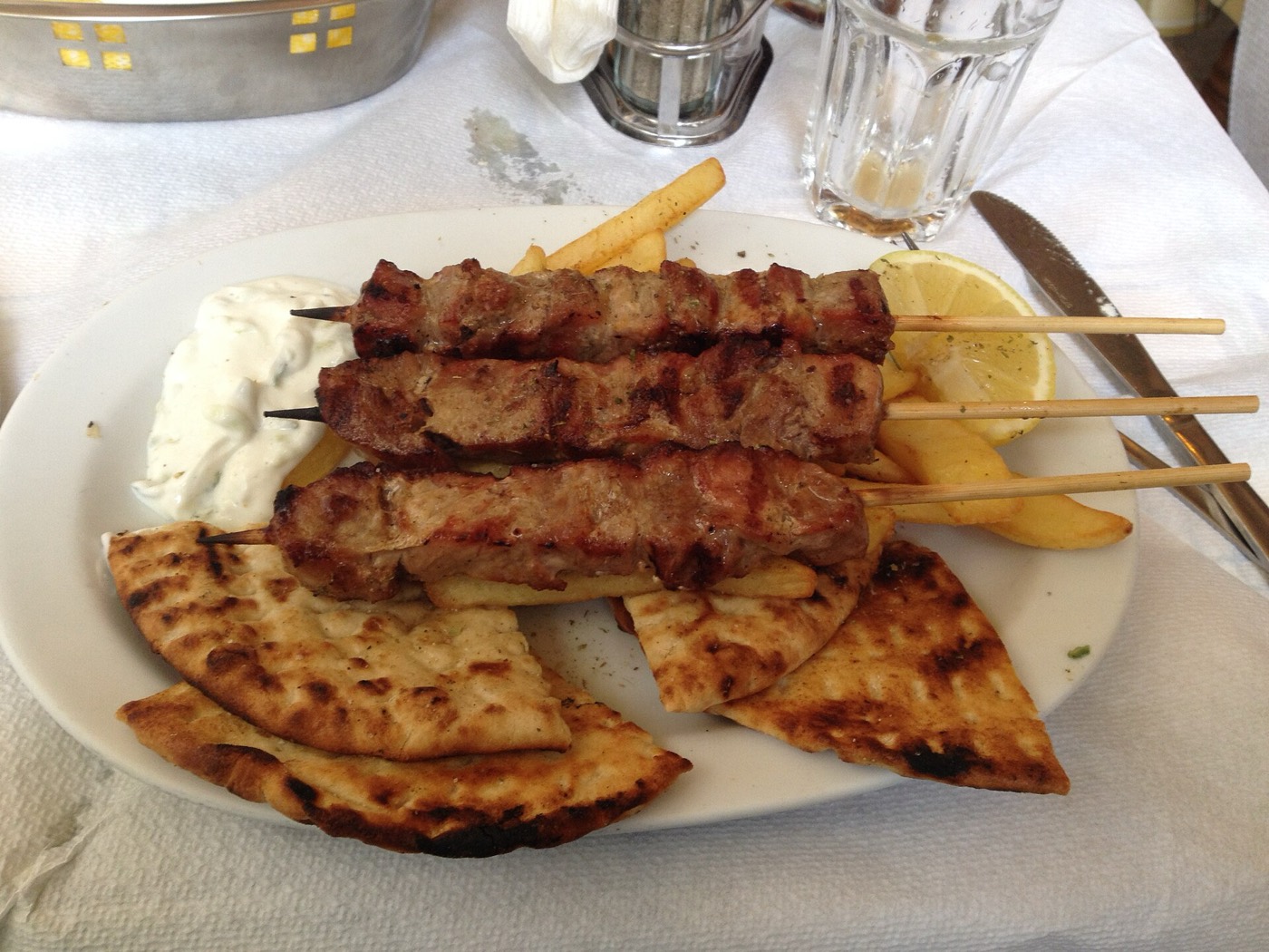 Souvlaki with pita, tomato and tzatziki